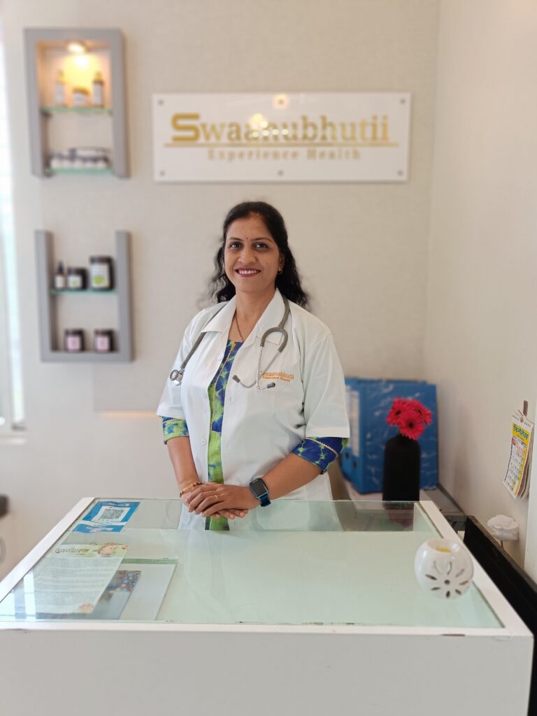Ayurvedic doctor consultation desk with brass mortar pestle, Ashwagandha and Brahmi herbs at Swaanubhutii holistic wellness clinic, Warje Pune
